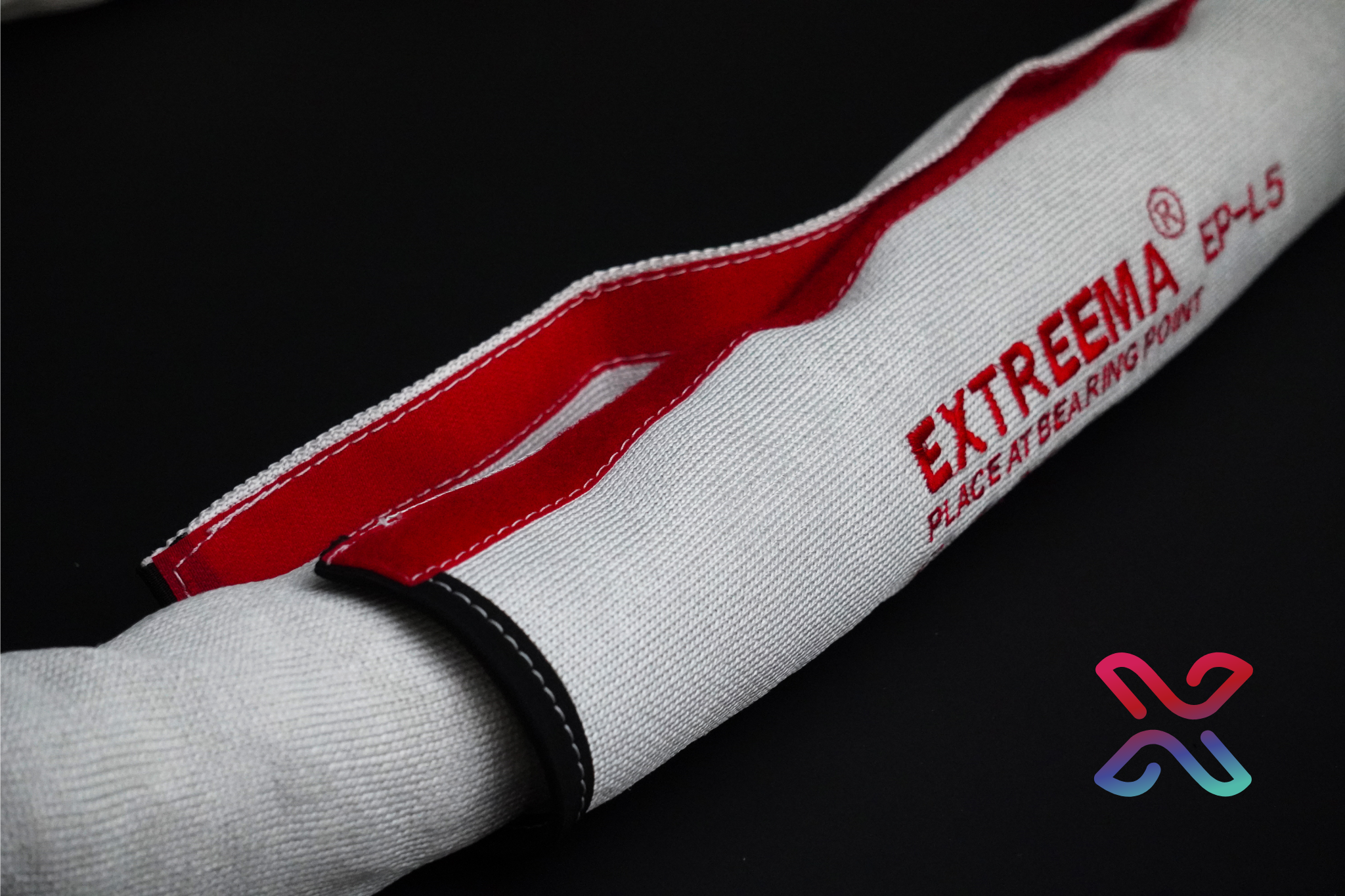 Extreema EP-L HMPE protective sling sleeve fitted over a white round sling