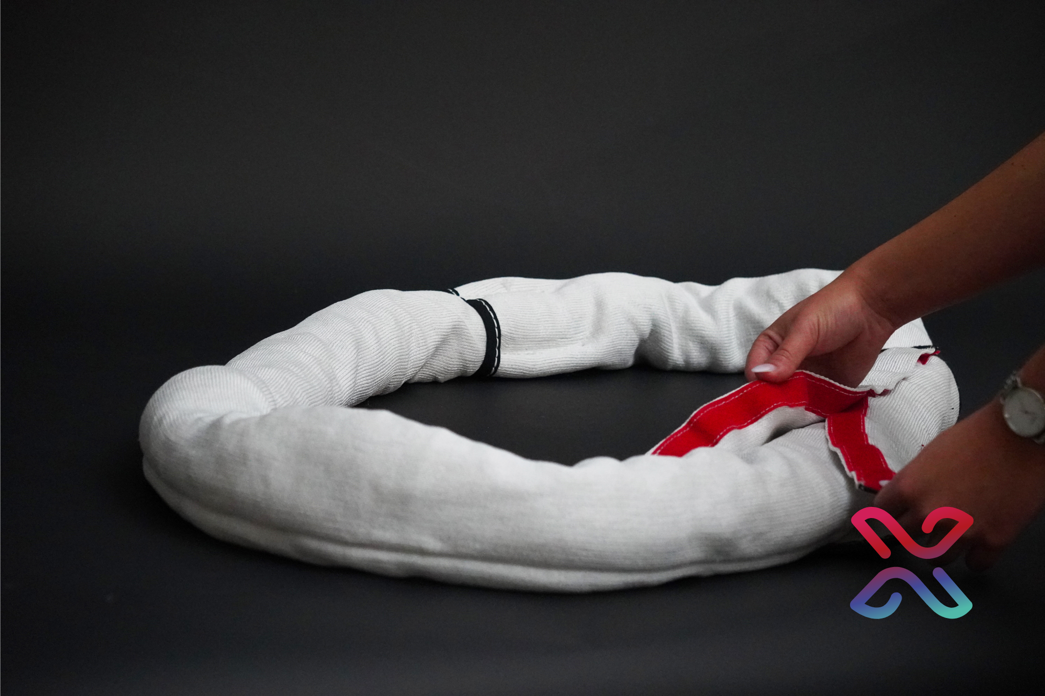 Rigger closing the hook and loop strip on an Extreema EP-L protective sling sleeve